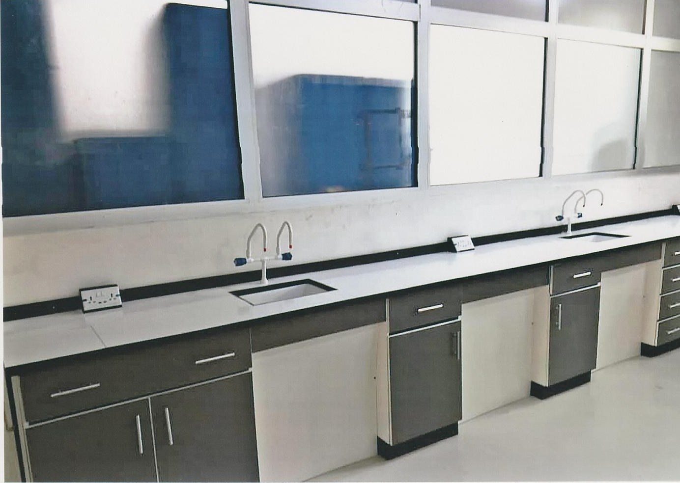 Completed lab — long run of benches with sinks and gooseneck taps
